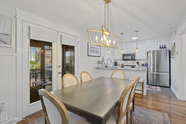 821 Planters Point Dr, Canton, MS 39046 - dining space with a chandelier, dark wood-style floors, and french doors