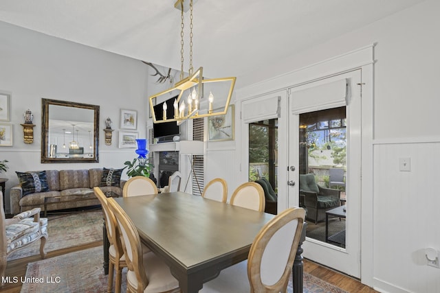 821 Planters Point Dr, Canton, MS 39046 - dining space with french doors, wood finished floors, a decorative wall, a wainscoted wall, and a chandelier