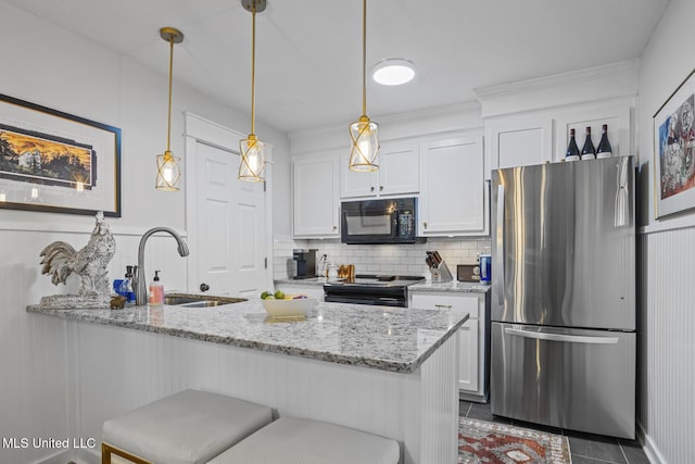 821 Planters Point Dr, Canton, MS 39046 - kitchen with black appliances, white cabinetry, decorative backsplash, light stone counters, and hanging light fixtures