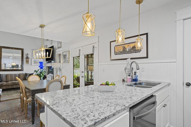 821 Planters Point Dr, Canton, MS 39046 - kitchen with stainless steel dishwasher, french doors, wainscoting, white cabinetry, and light stone countertops