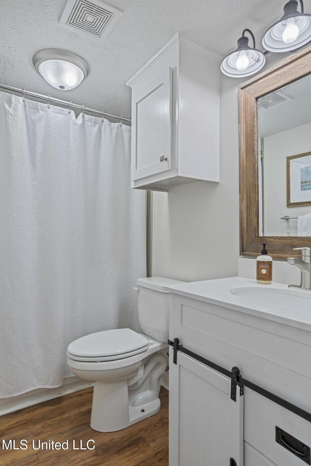 821 Planters Point Dr, Canton, MS 39046 - full bathroom with vanity, wood finished floors, a textured ceiling, and a shower with curtain