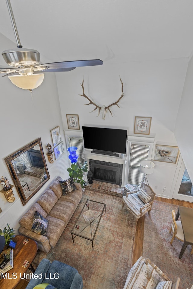 821 Planters Point Dr, Canton, MS 39046 - living area featuring a ceiling fan, a fireplace, and wood finished floors