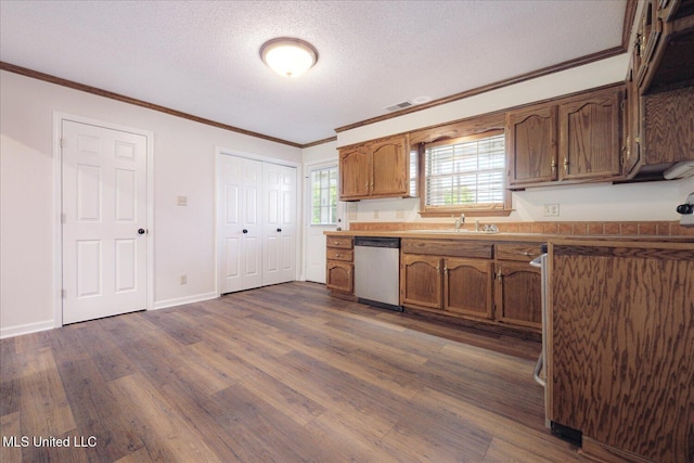 2185 Plum Point Rd, Southaven, MS 38672 - kitchen featuring stainless steel dishwasher, dark wood-style floors, ornamental molding, a sink, and baseboards