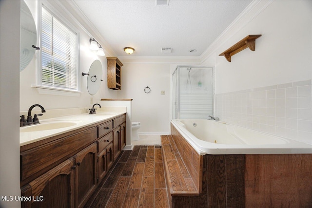 2185 Plum Point Rd, Southaven, MS 38672 - bathroom with a bath, double vanity, a shower stall, toilet, and wood finished floors