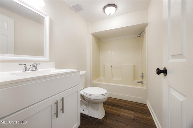 2185 Plum Point Rd, Southaven, MS 38672 - bathroom featuring vanity, wood finished floors, toilet, bathing tub / shower combination, and baseboards