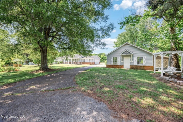 2185 Plum Point Rd, Southaven, MS 38672 - ranch-style home with a front lawn, a pergola, an outbuilding, asphalt driveway, and brick siding