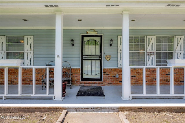 2185 Plum Point Rd, Southaven, MS 38672 - doorway to property with covered porch and brick siding