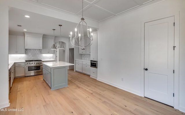 614 Cobalt Way, Brandon, MS 39042 - kitchen with tasteful backsplash, decorative light fixtures, stainless steel stove, a kitchen island, and light hardwood / wood-style floors