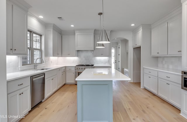 614 Cobalt Way, Brandon, MS 39042 - kitchen with a kitchen island, sink, hanging light fixtures, stainless steel appliances, and wall chimney range hood