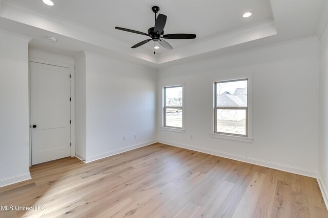 614 Cobalt Way, Brandon, MS 39042 - empty room with crown molding, light hardwood / wood-style flooring, ceiling fan, and a tray ceiling