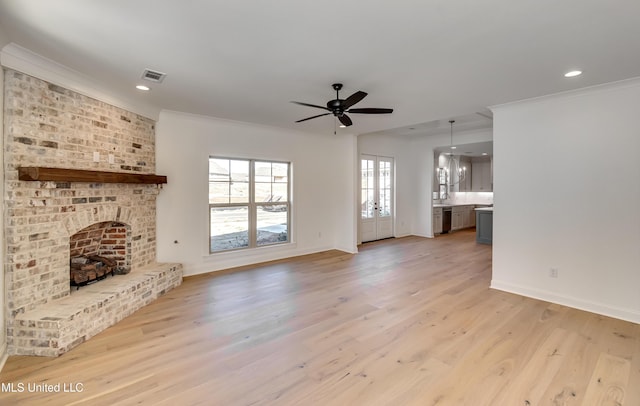 614 Cobalt Way, Brandon, MS 39042 - unfurnished living room featuring ceiling fan, ornamental molding, a fireplace, and light wood-type flooring