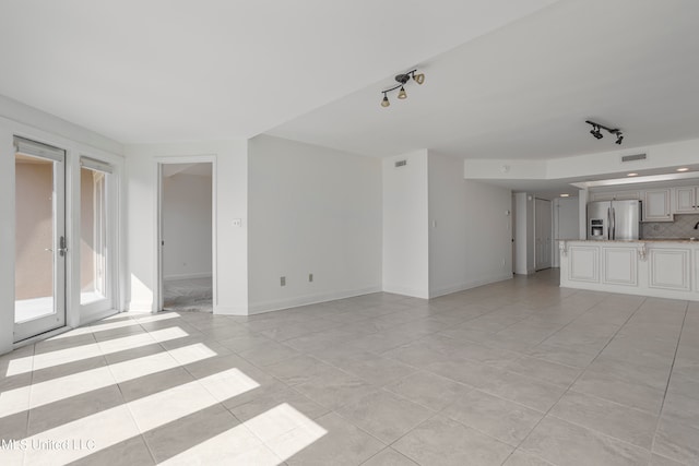 unfurnished living room with light tile patterned floors