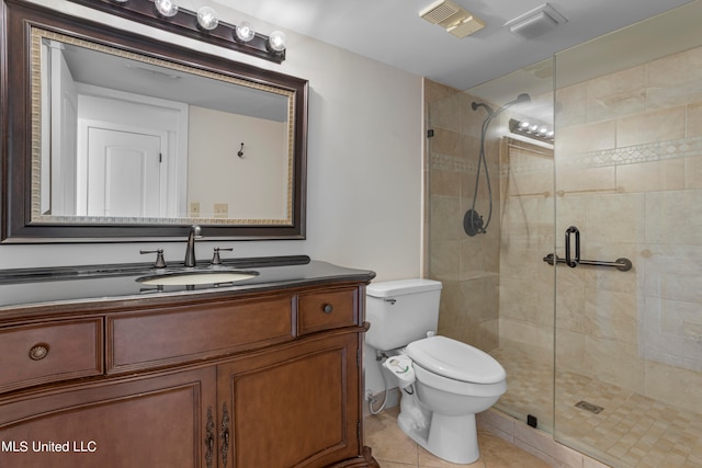 bathroom featuring vanity, tile patterned floors, toilet, and walk in shower