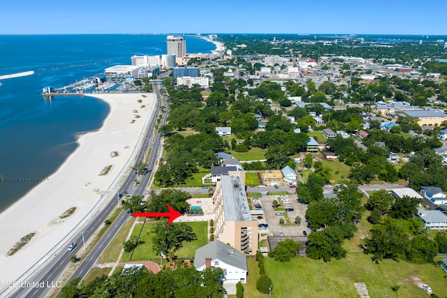 birds eye view of property with a water view and a view of the beach