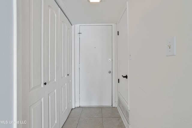 corridor featuring light tile patterned floors