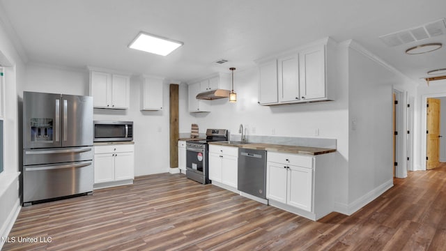 9083 Old River Rd Lot 1, Petal, MS 39465 - kitchen with appliances with stainless steel finishes, wood finished floors, under cabinet range hood, crown molding, and baseboards