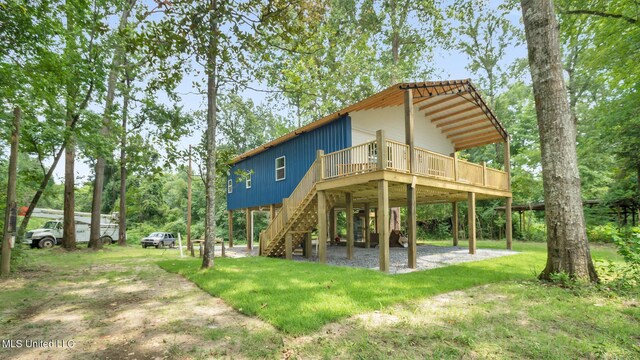 9083 Old River Rd Lot 1, Petal, MS 39465 - rear view of property with a carport, a deck, stairs, and a yard