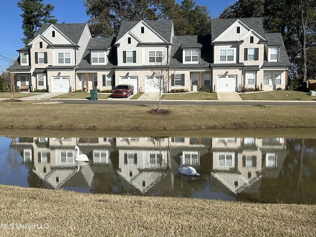 dock area featuring a water view and a lawn