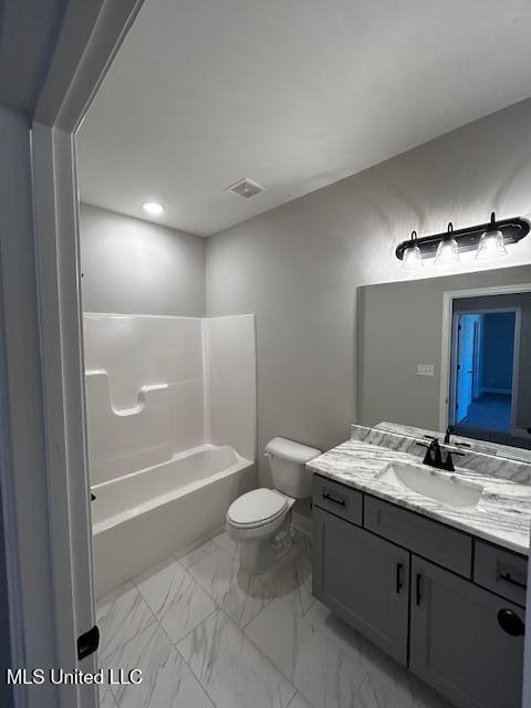 full bathroom featuring toilet, vanity, and tub / shower combination