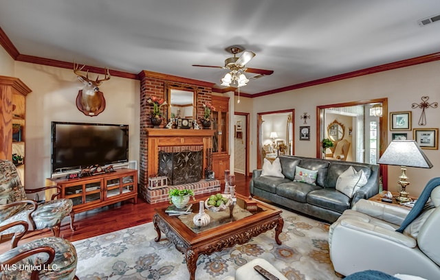 26 Woodgate Dr, Brandon, MS 39042 - living room with crown molding, ceiling fan, a fireplace, and visible vents