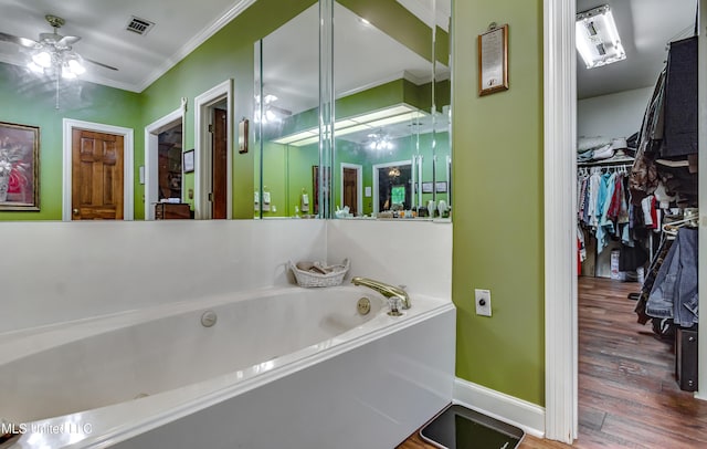 26 Woodgate Dr, Brandon, MS 39042 - bathroom with ceiling fan, a bath, visible vents, crown molding, and wood finished floors