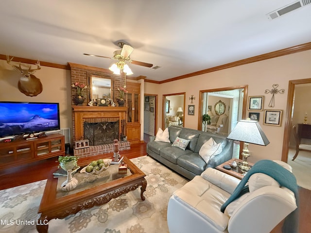 26 Woodgate Dr, Brandon, MS 39042 - living area featuring crown molding, a fireplace, a ceiling fan, and visible vents