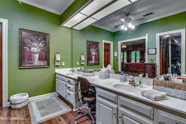 26 Woodgate Dr, Brandon, MS 39042 - bathroom with visible vents, ornamental molding, double vanity, wood finished floors, and ceiling fan