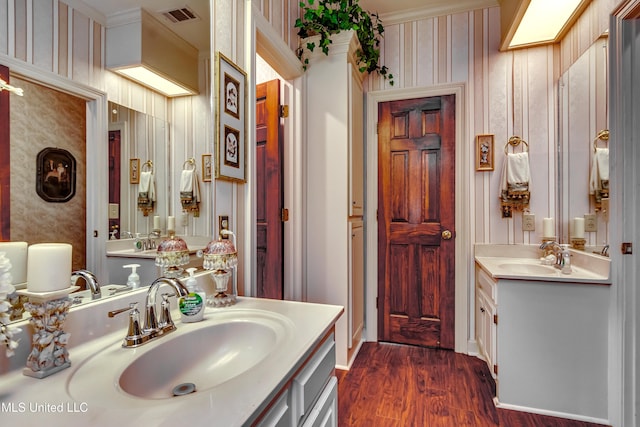 26 Woodgate Dr, Brandon, MS 39042 - bathroom with a sink, wallpapered walls, wood finished floors, and visible vents