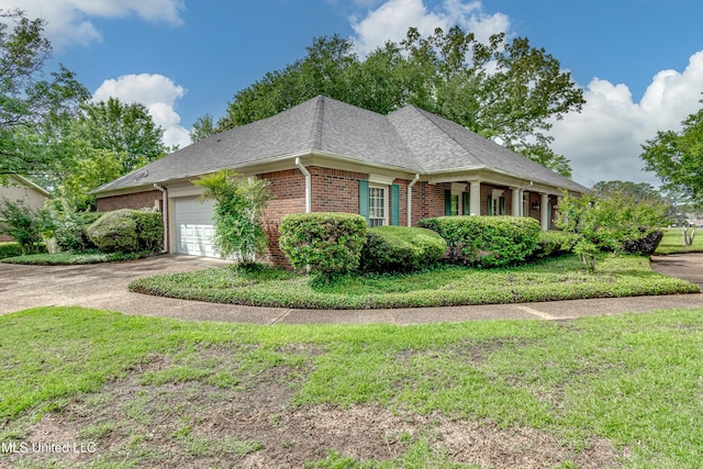 26 Woodgate Dr, Brandon, MS 39042 - view of side of property featuring brick siding, an attached garage, a lawn, and driveway