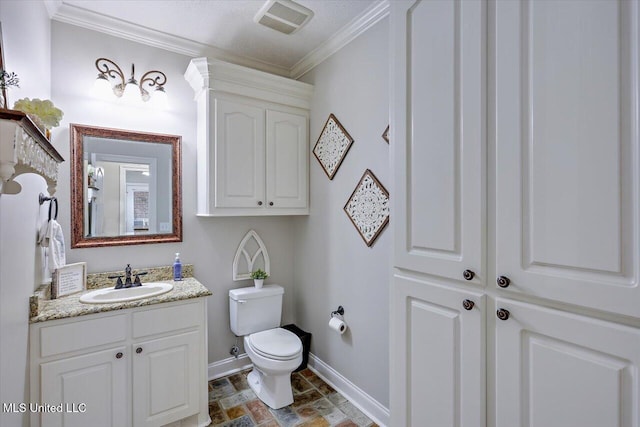 bathroom featuring vanity, ornamental molding, and toilet