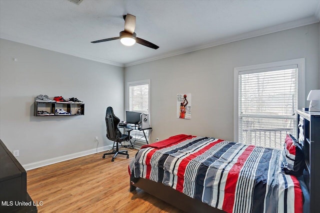 bedroom featuring hardwood / wood-style floors, ornamental molding, and ceiling fan