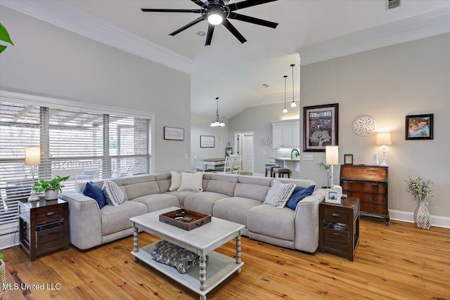 living room with crown molding, high vaulted ceiling, ceiling fan with notable chandelier, and light hardwood / wood-style floors