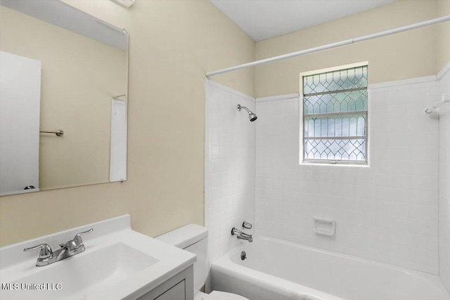 full bathroom featuring vanity, toilet, and tiled shower / bath