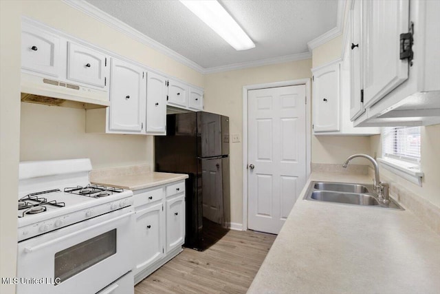 kitchen featuring black fridge, sink, ornamental molding, white cabinetry, and white range with gas cooktop