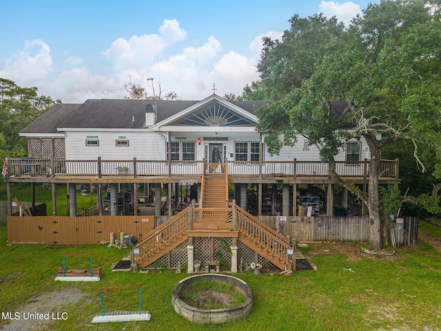 back of house with a lawn and a wooden deck