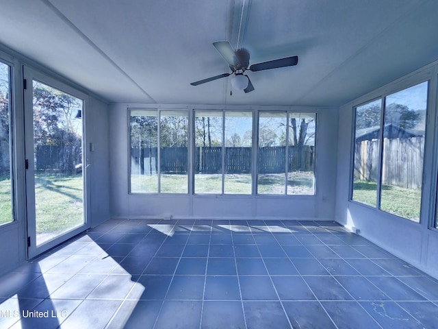 unfurnished sunroom featuring a ceiling fan