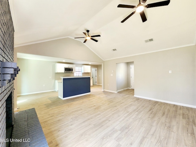 unfurnished living room with visible vents, a brick fireplace, baseboards, vaulted ceiling, and light wood-style floors