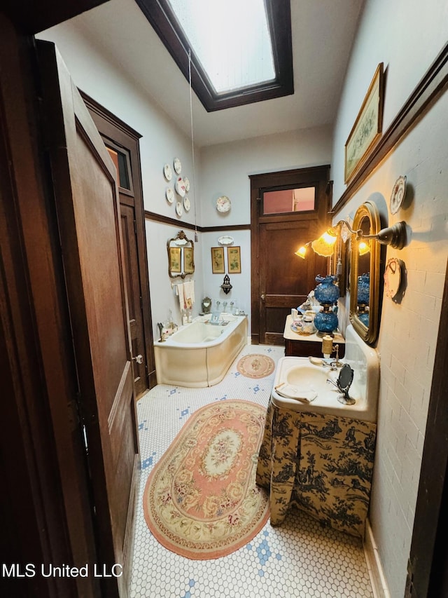 bathroom featuring sink, a washtub, and tile patterned floors