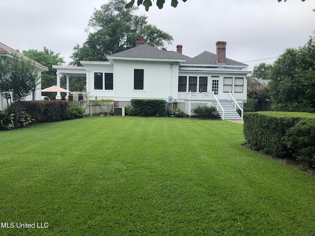 rear view of property featuring central AC, a lawn, and a wooden deck