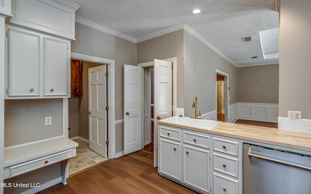 kitchen featuring sink, crown molding, white cabinetry, a textured ceiling, and dishwasher