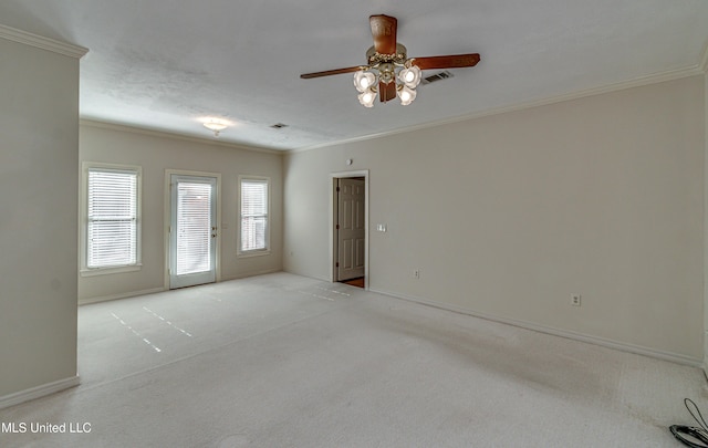 carpeted spare room with crown molding and ceiling fan