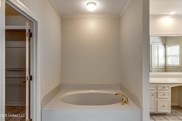 bathroom featuring a washtub, vanity, and ornamental molding