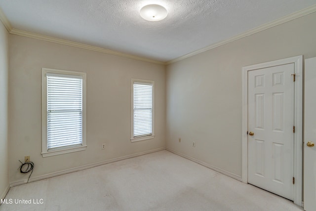 empty room with crown molding, light colored carpet, and a healthy amount of sunlight