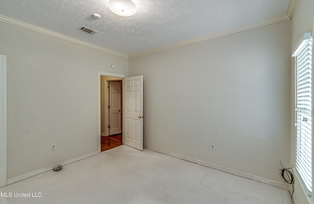 unfurnished room featuring ornamental molding, a healthy amount of sunlight, carpet floors, and a textured ceiling