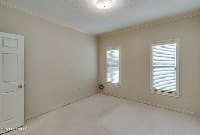 unfurnished room featuring ornamental molding, light colored carpet, and a textured ceiling