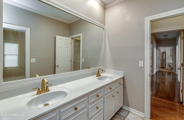 bathroom with ornamental molding and vanity