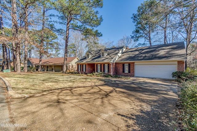 view of front of home featuring a garage and a front lawn