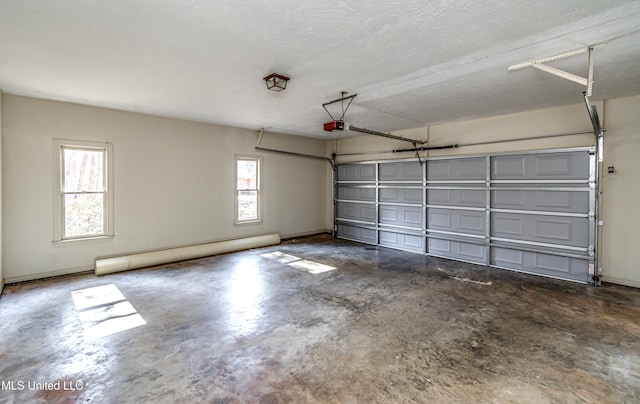 garage featuring a baseboard radiator and a garage door opener