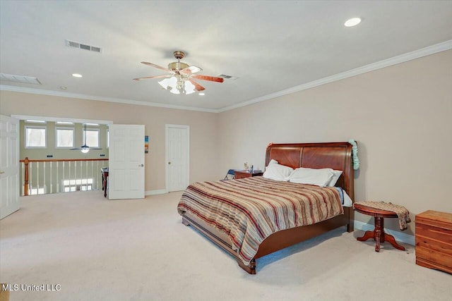 carpeted bedroom featuring ceiling fan and crown molding