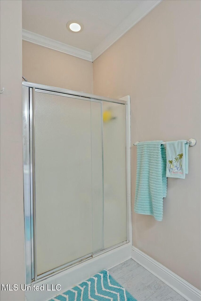 bathroom featuring walk in shower and ornamental molding